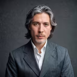 a man with grey hair wearing a suit