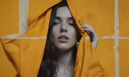 a woman that is covering her face with a blanket