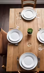a table setting is arranged for dinner with empty plates