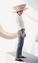 a woman in grey slacks and a white blouse