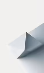 the angled view of an origami model on a white surface