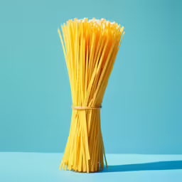 spaghetti tied up in a bundle on blue background