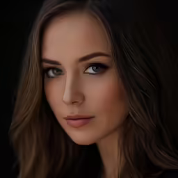 a woman in black looking into the camera