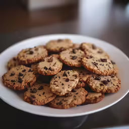 a plate of cookies with chocolate chip toppings