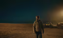 a man standing in the desert at night