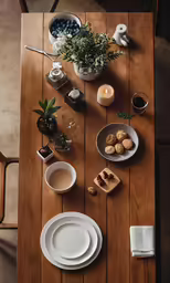 a table with plates, cups, and saucers sits on top of the wooden floor