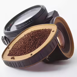 two lens sitting on top of each other with dirt inside