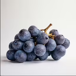 a fruit cluster of grapes on a white background