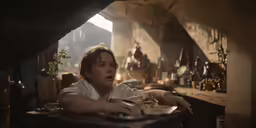 a woman sitting at a table with food