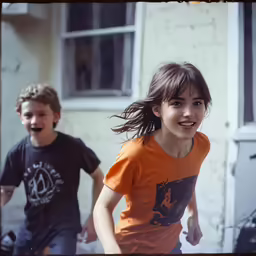 two children running near one another in the background