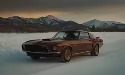 an old - fashioned muscle car drives through the snowy plains