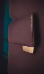 close up view of a folded cushion with a metal chain attached
