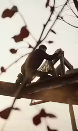 the person is working on the top of a building