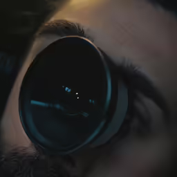 close up of eye with camera lens pointed upward