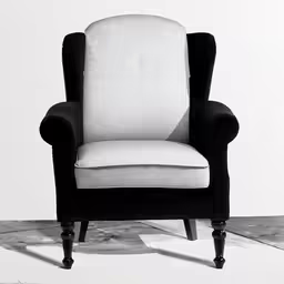 a black and white chair with a white pillow