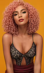 a woman wearing a black bra with orange hair