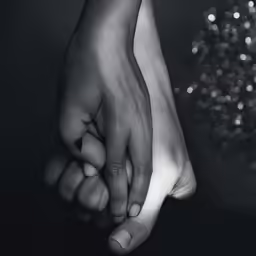 two hands with bracelets are touching each other