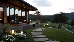 a lawn outside at night overlooking a valley