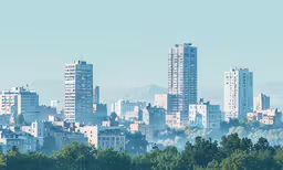 many skyscrapers line the skyline of some large and tall buildings