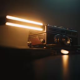 a camera sitting on top of a table next to a light