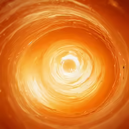 a bright orange spiral pattern with a small light inside