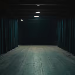 an empty stage with curtains and lights