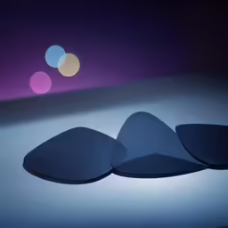 three black oval plates on a dark background