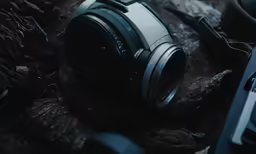 a sony camera and some other objects on a wood floor