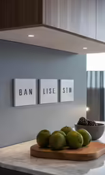 some apples and green pears are on a counter