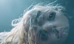 woman with white hair and eyes appearing to be half covered by water