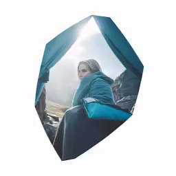 woman in blue coat sitting on blue chair under blue tent