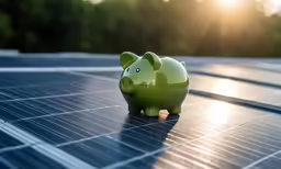 an piggy bank on top of solar panels