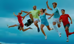 a group of people are jumping up in the air