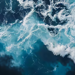 a large body of water with lots of waves in it