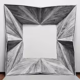 a white and grey artwork with wooden flooring