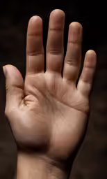 the hand is holding a piece of bread