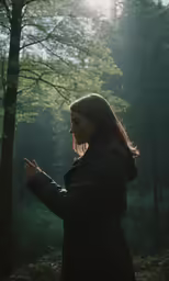 the woman is praying on the woodside