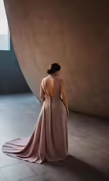 a woman in a long dress with the back of her dress pulled down
