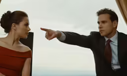 a man pointing at another woman and pointing toward the other man