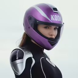 a beautiful woman wearing a purple helmet next to the ocean