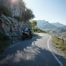 a motorcycle parked on the side of a mountain road