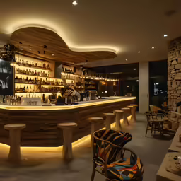 a wine bar and lounge with stools around it