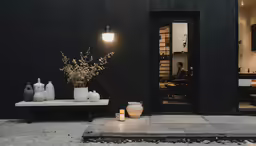 vases are lined up outside a dark room