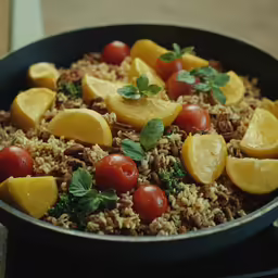 a bowl with rice, tomatoes, meat and fresh herbs