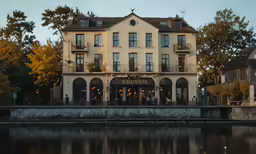 this is a building near the water with some people standing outside