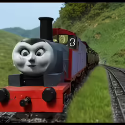 a large thomas the train on a track next to green grass