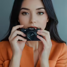 woman holding a camera and taking a picture