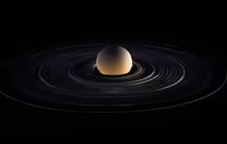 an egg on top of a black disk in the dark