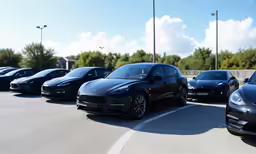 five different models of cars are lined up in a parking lot