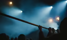 people holding onto the top bars of a stage